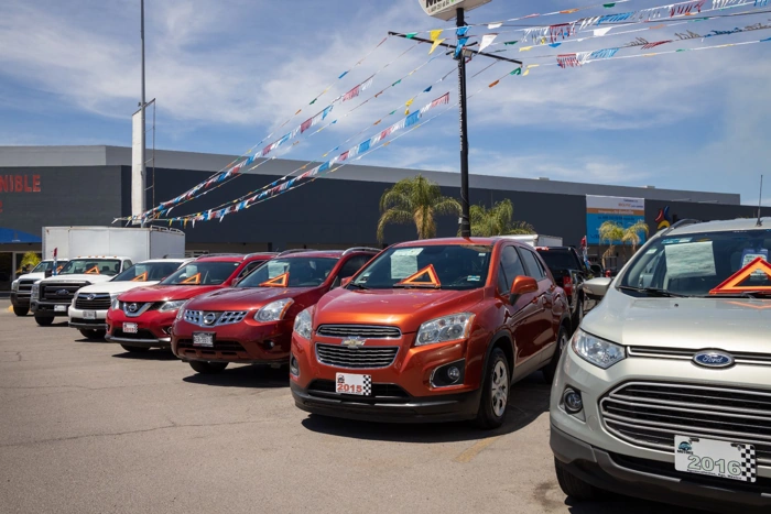 Carros enfileirados em loja de seminovos. Como consultar tabela FIPE pela placa?
